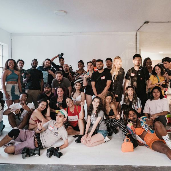A group of diverse people sitting in a circle during a yoga session, smiling.